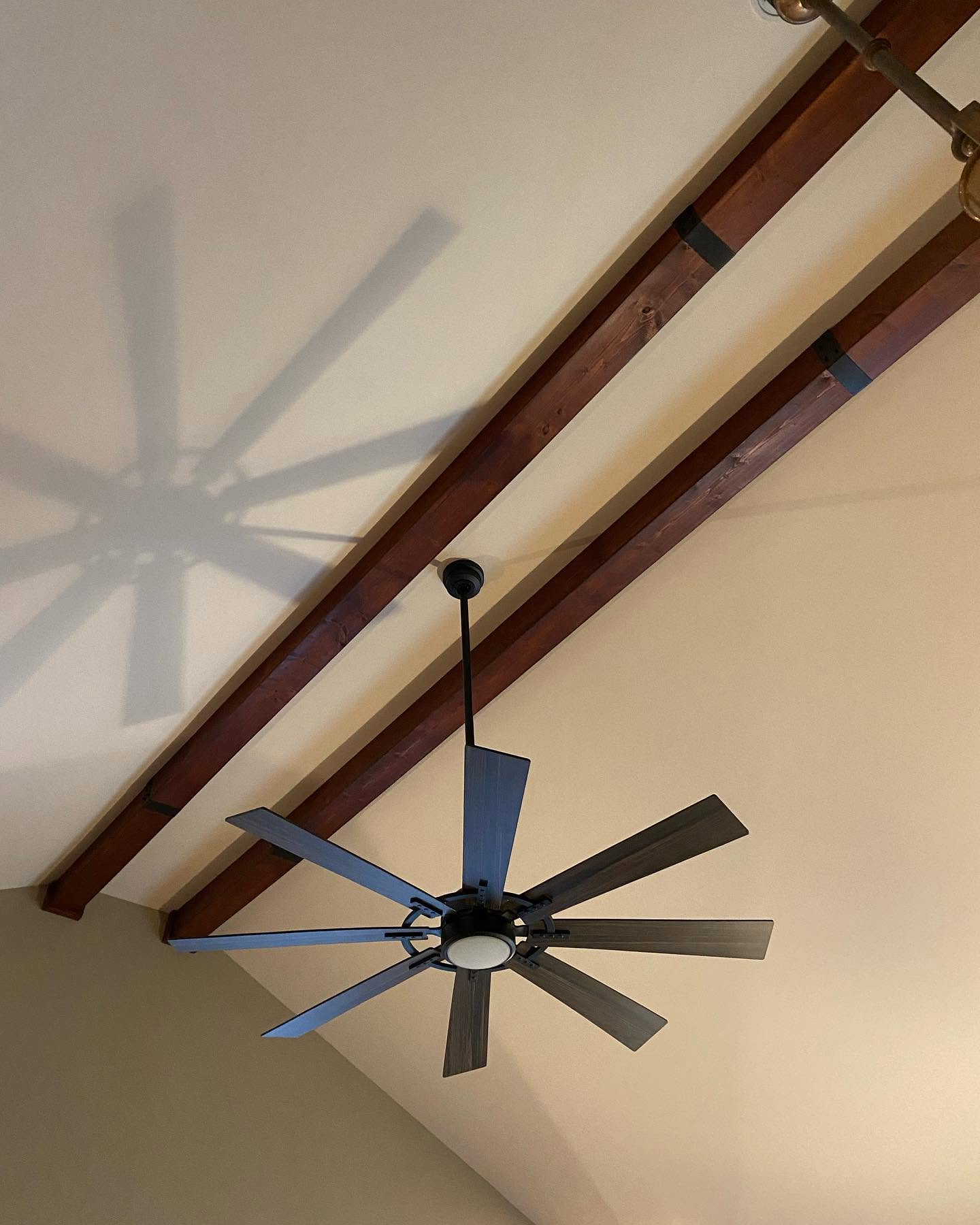 Close-up of vaulted ceiling with stained beams and crisp paint lines